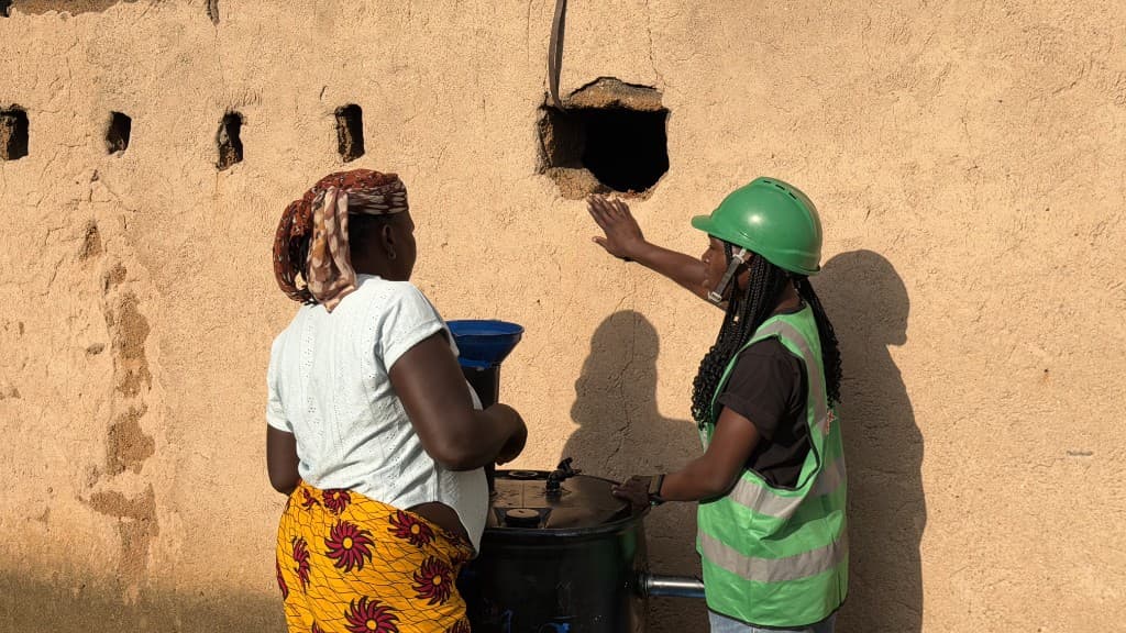 Biospark community members working with a biogas system